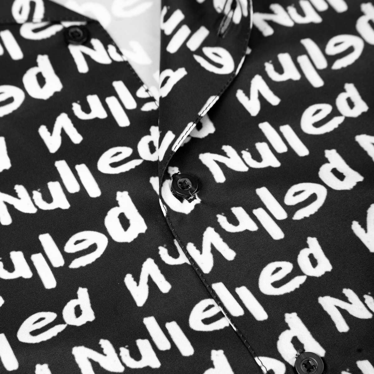 Black shirt with white text pattern on a mannequin