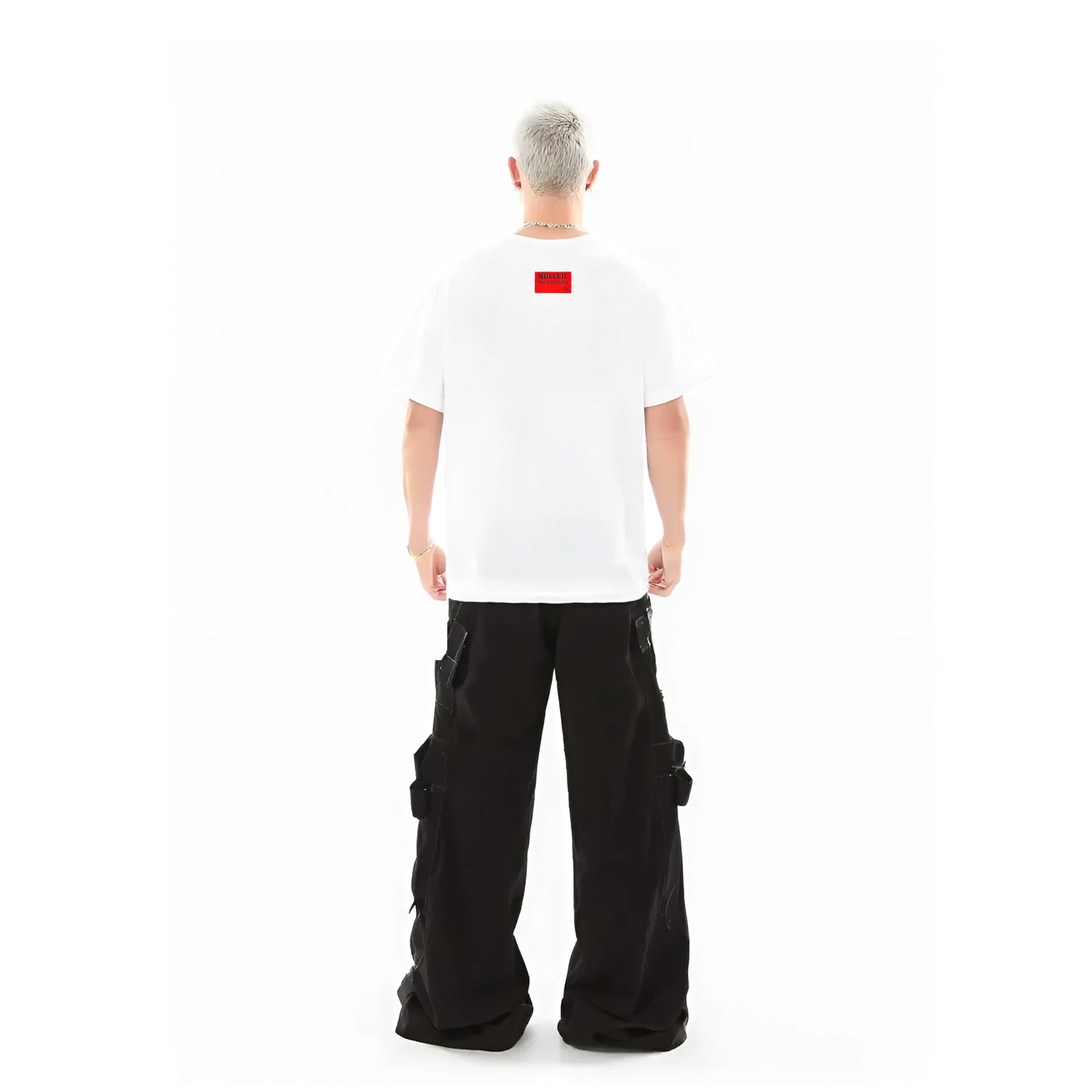 Person wearing a white t-shirt with a red logo and black cargo pants on a white background