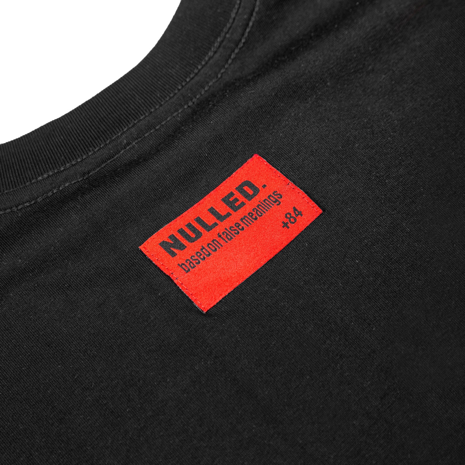 Black t-shirt with a red 'NULLED.' label on a white background