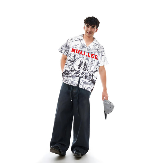 Person wearing a patterned shirt with text and dark pants on a white background