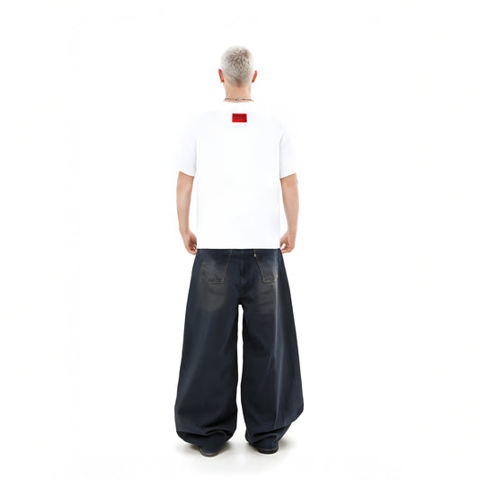 Person wearing a white t-shirt with a red logo and dark blue wide-leg pants on a white background