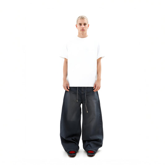 Person wearing a white t-shirt and black wide-leg pants on a white background