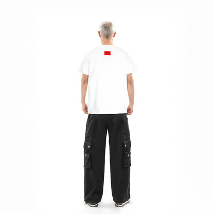Person wearing a white t-shirt with a red logo and black cargo pants on a white background