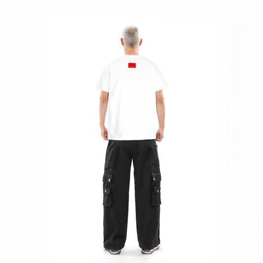Person wearing a white t-shirt with a red logo and black cargo pants on a white background