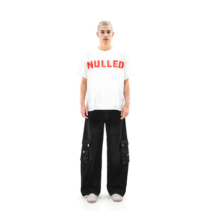 Person wearing a white t-shirt with 'NULLED' printed in red on a white background