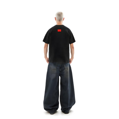 Person wearing a black t-shirt with a red logo on the back, standing against a white background.