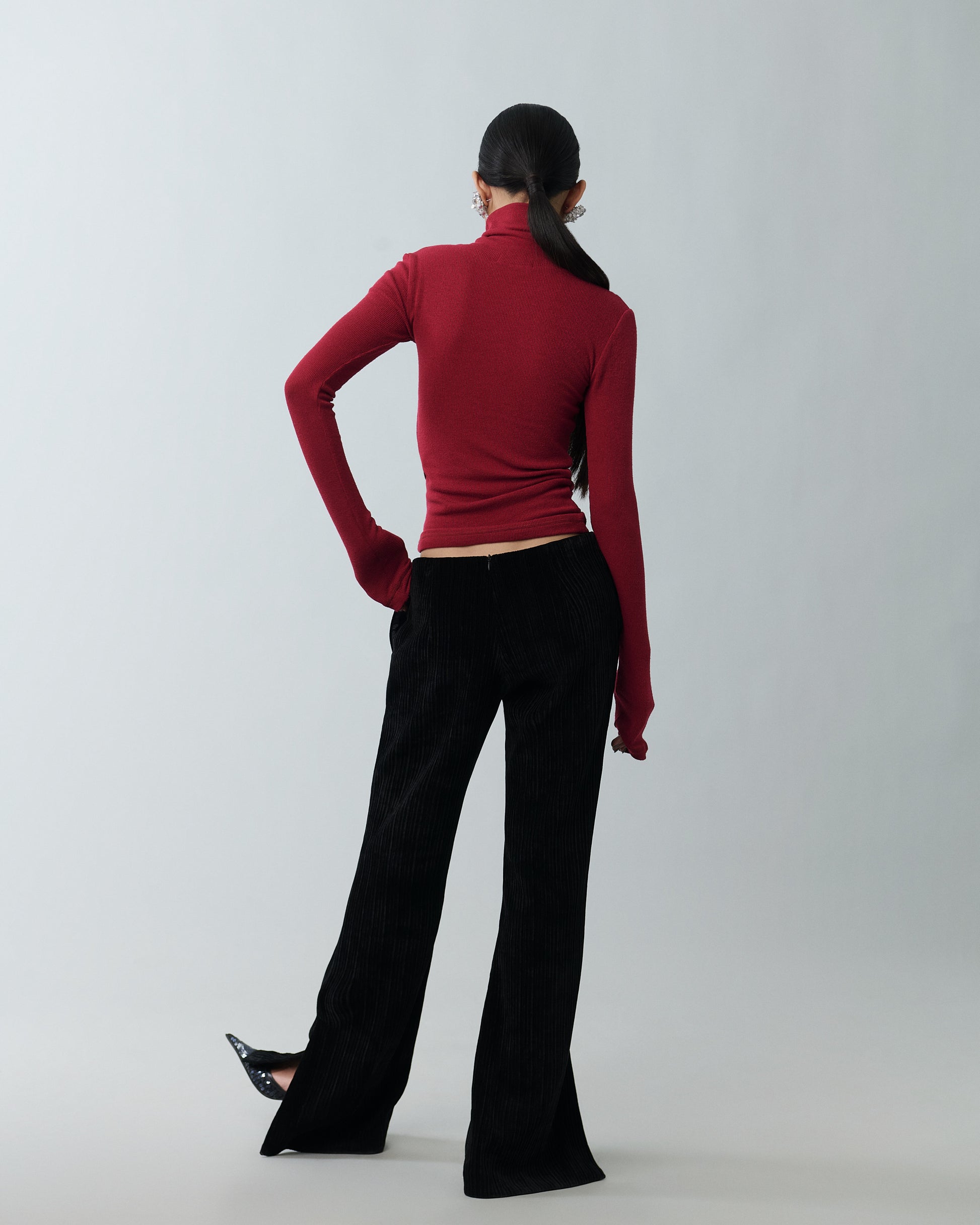 Model styling black velvet pants with heels