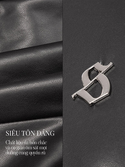 Metallic logo on black leather surface with text in Vietnamese