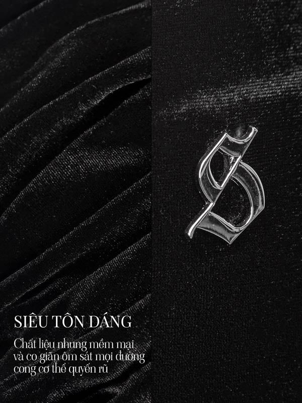 Silver brooch on a black textured background with text overlay.