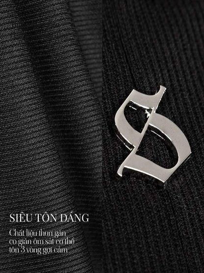 Silver brooch on a black textured fabric background