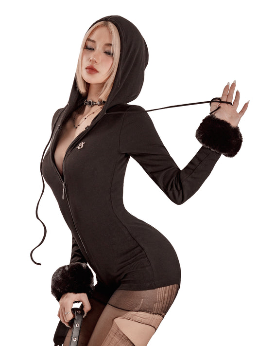 Person wearing a black hooded outfit with fur cuffs on a white background