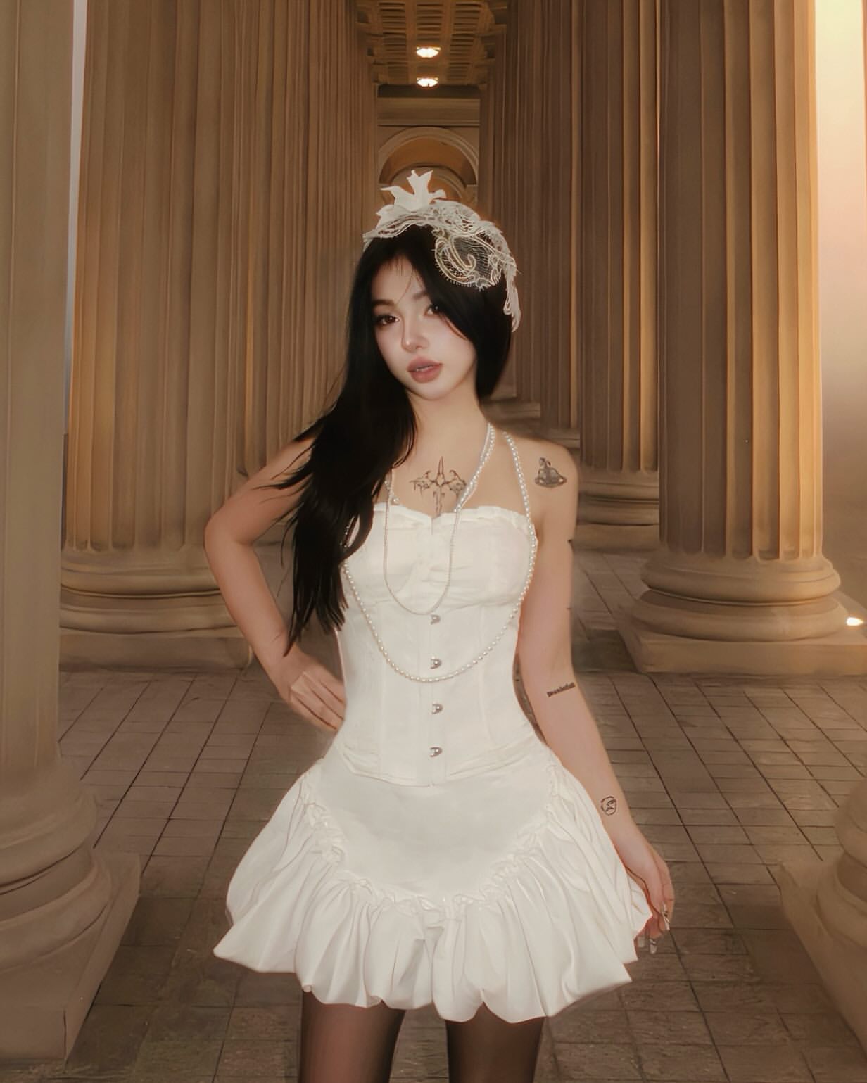 Woman in a white dress standing in a classical architecture setting