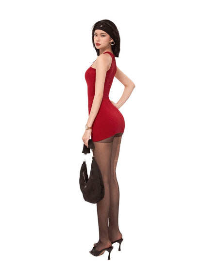 Woman in a red dress and black stockings holding a brown handbag on a white background