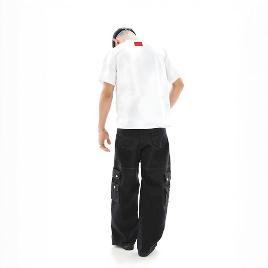 Person wearing a white shirt and black cargo pants on a white background