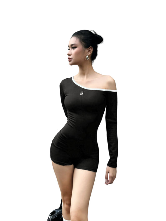 Woman wearing a black off-shoulder top and shorts on a white background