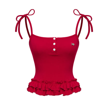 Red tank top with ruffled bottom and tied straps on a white background