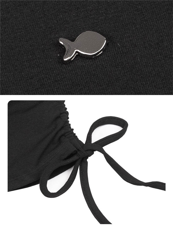 Black top with a fish-shaped brooch and a close-up of a black bow.
