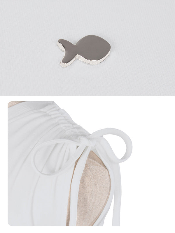 White bikini top with fish-shaped cutout on a light gray background