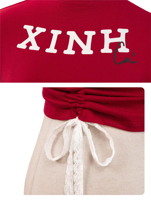 Red top with 'XINH' text and beige pants with lace details.