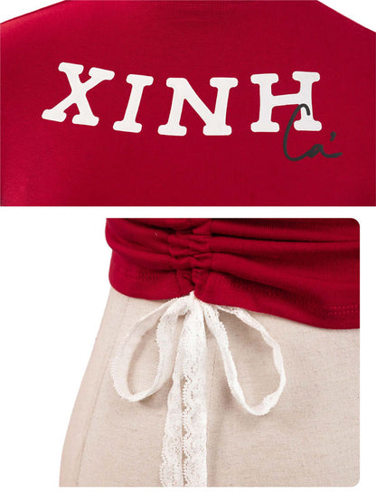 Red top with 'XINH' text and beige pants with lace details.