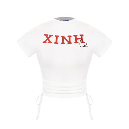 White t-shirt with red text 'XINH' on a white background