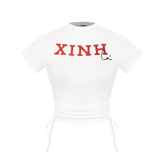 White t-shirt with red text 'XINH' on a white background