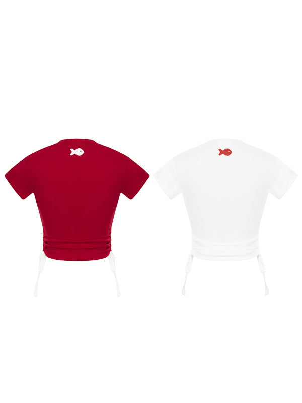 Red and white t-shirts with fish designs on a white background