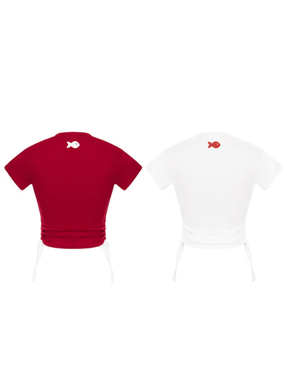 Red and white t-shirts with fish designs on a white background