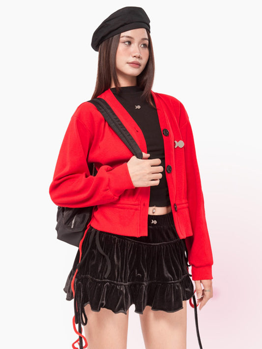 Person wearing a red jacket and black outfit with a backpack on a white background