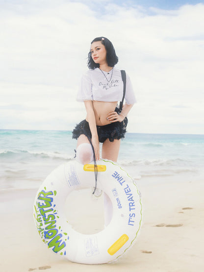 Woman holding a inflatable ring on a beach with ocean and sky in the background