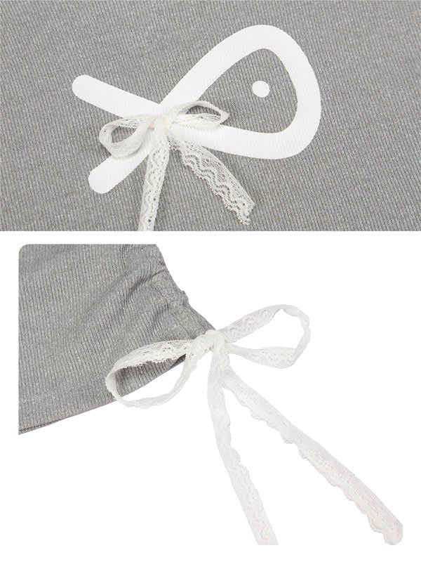 Gray fabric with white lace bow detail on a gray background