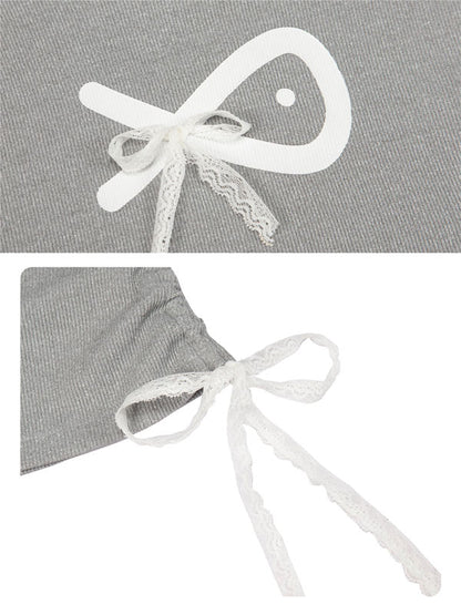 Gray fabric with white lace bow detail on a gray background