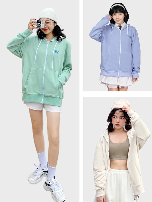 Three individuals wearing different colored hoodies against a white background
