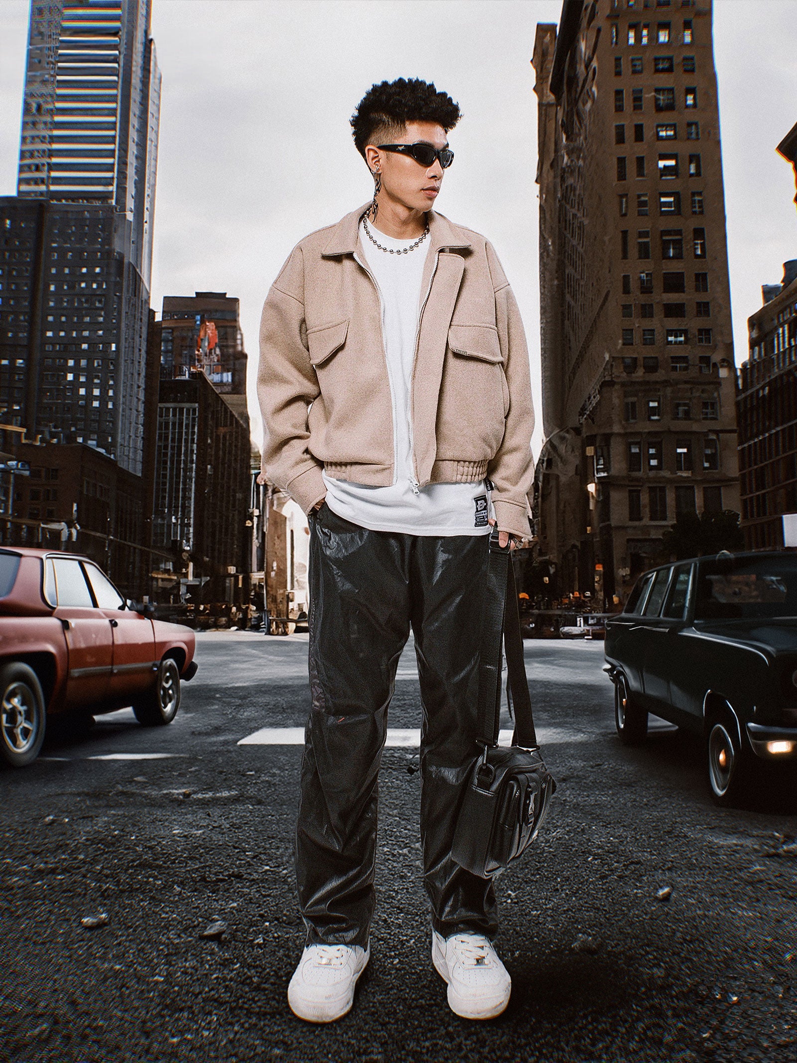 Person standing on a city street with tall buildings in the background