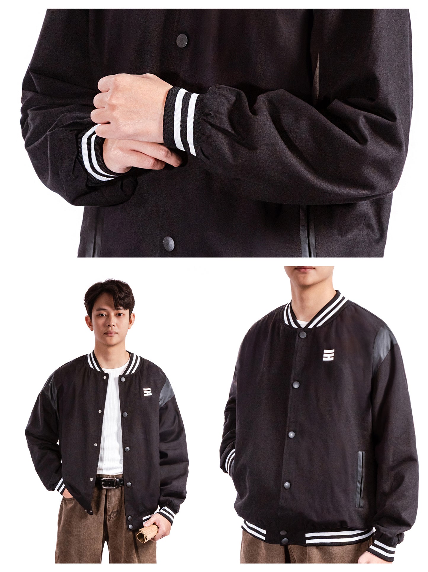 Black varsity jacket with white accents worn by a person on a white background