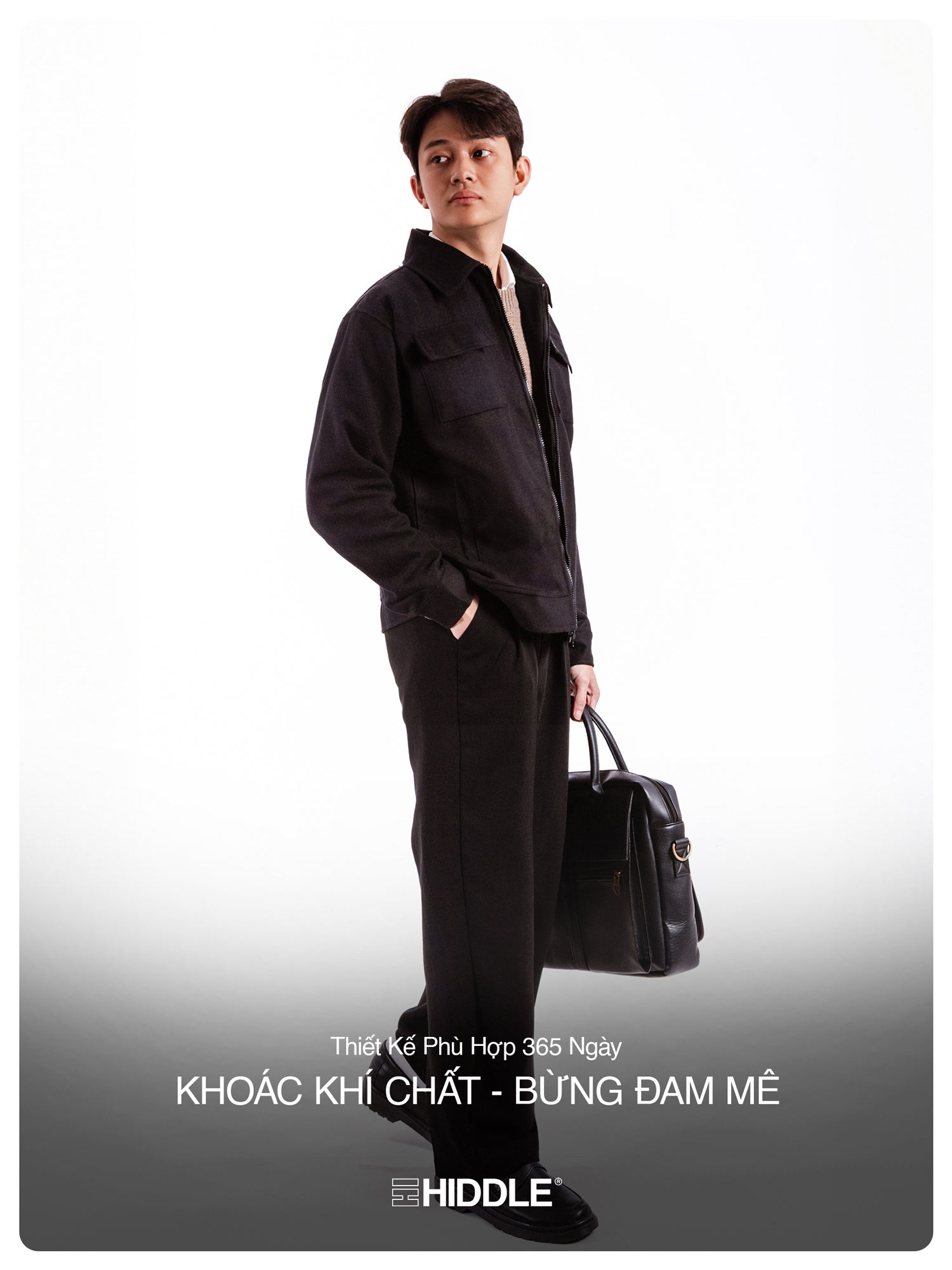 Man in black outfit holding a briefcase with Hiddle branding on a gray background
