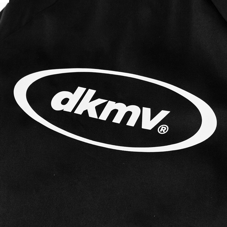 Black bag with white 'dkmv' logo on a black background