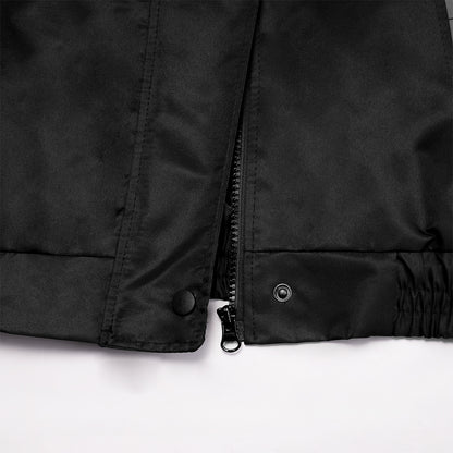 Close-up of a black jacket with buttons and a zipper on a white background