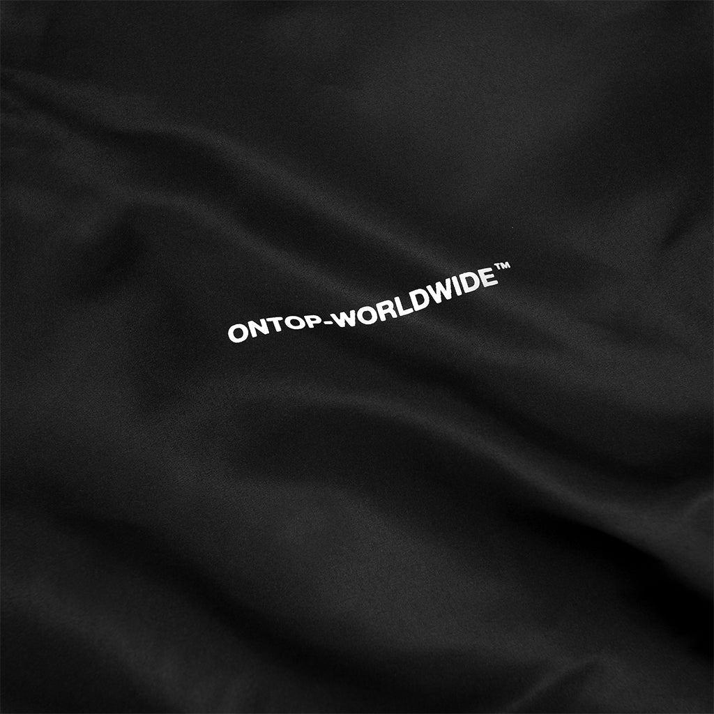 Black fabric with 'ONTOP-WORLDWIDE' text embroidered on it