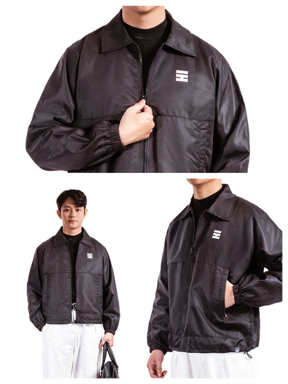 Black jacket with a brand logo worn by a person on a white background
