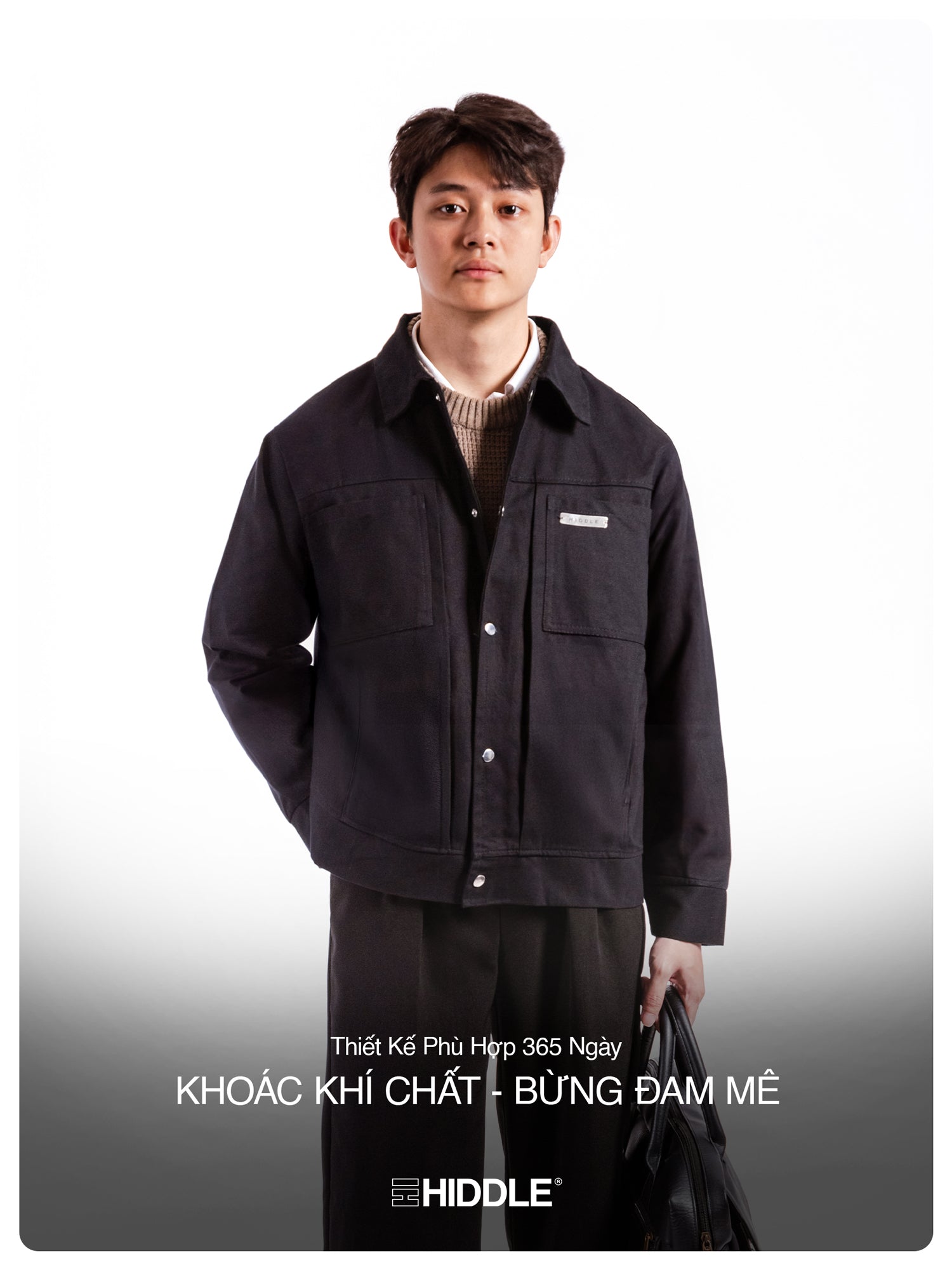 Man wearing a black jacket with text on a gray background