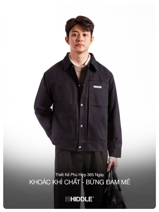 Man wearing a black jacket with text on a gray background