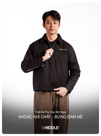 Man wearing a black jacket with 'Hiddle' branding on a white background