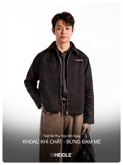 Man wearing a dark jacket with 'Hiddle' branding on a white background