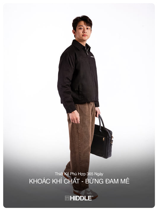Man holding a briefcase against a white background with Hiddle branding.