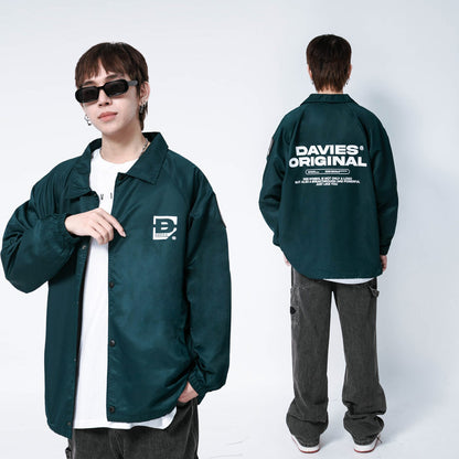 Person wearing a green jacket with brand logos on a white background