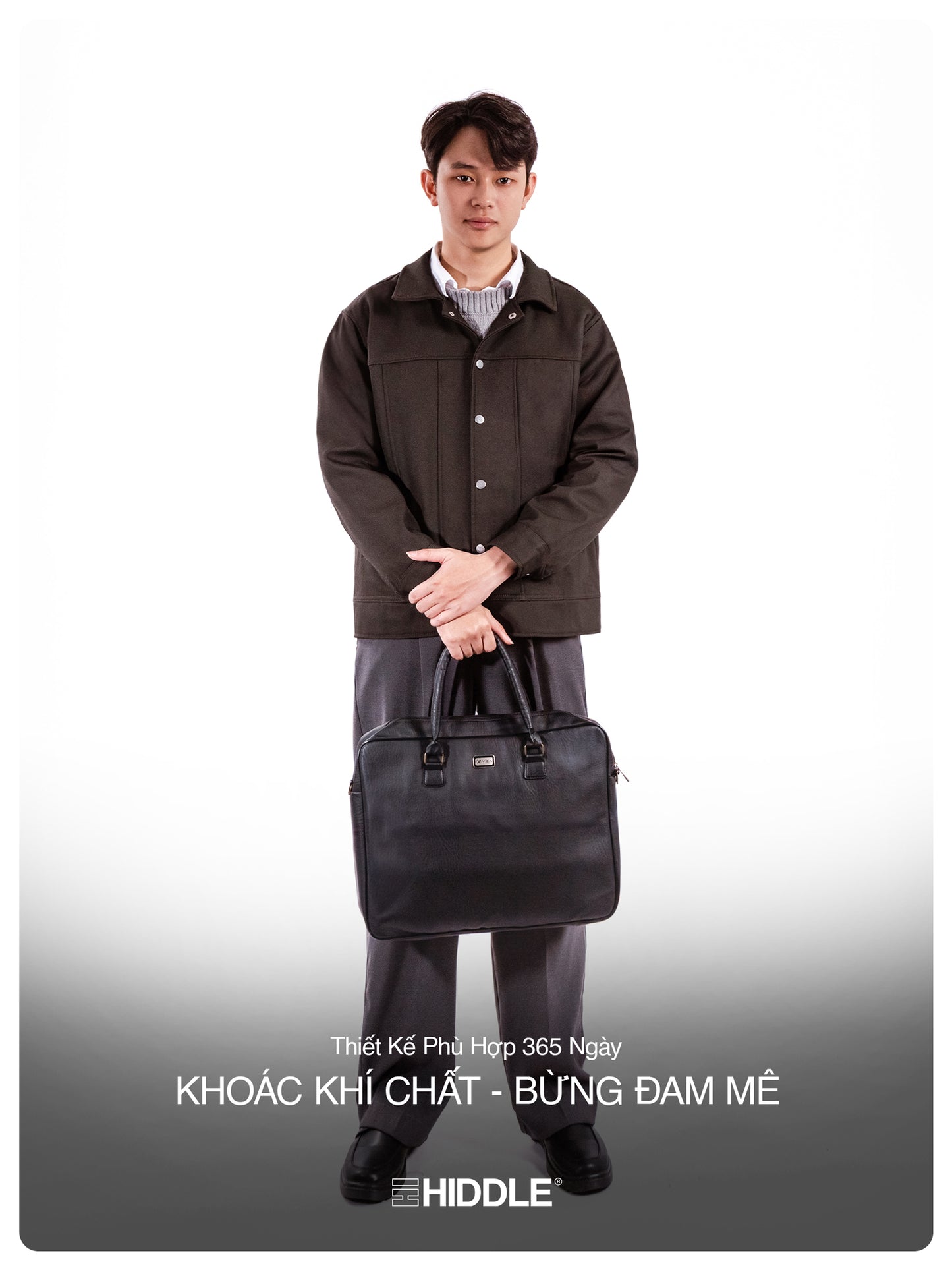 Man holding a black briefcase wearing a brown coat on a white background
