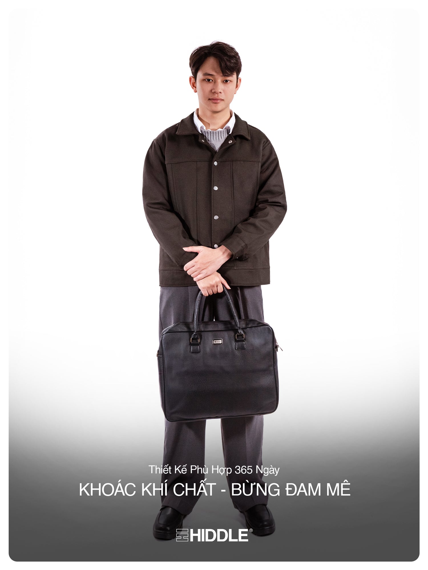Man holding a black briefcase wearing a brown coat on a white background