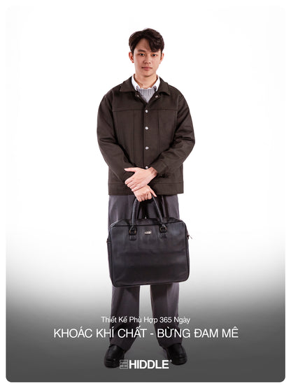 Man holding a black briefcase wearing a brown coat on a white background
