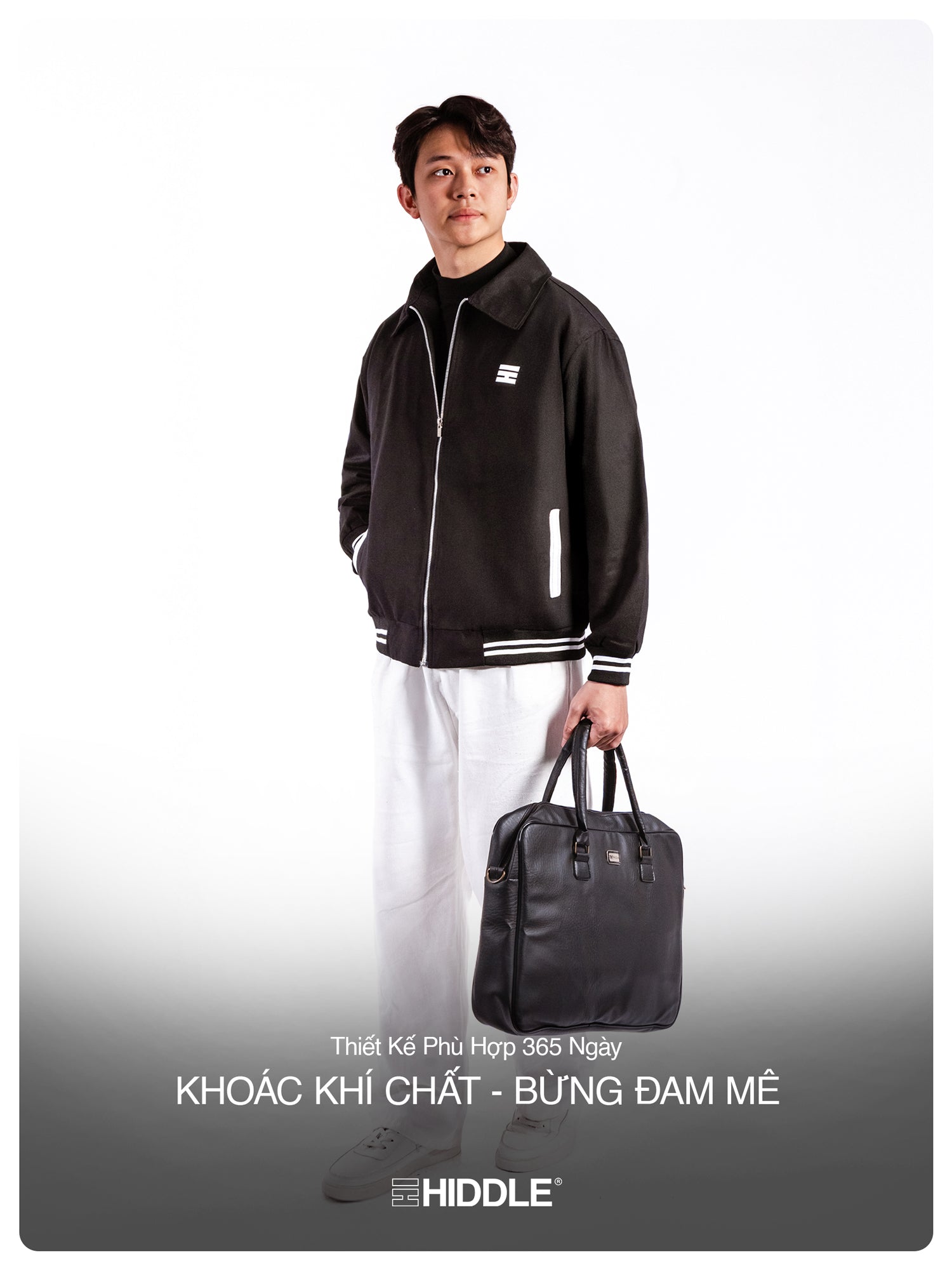 Person wearing a black jacket holding a black bag on a white background with Hiddle branding.
